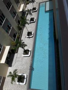 an overhead view of a swimming pool in a building at The Cozy Place Stanford 2 in Silang +10 photos