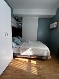 a bedroom with a bed in the corner of a room at JAN Studio CDO Condo Stay in Lapasan