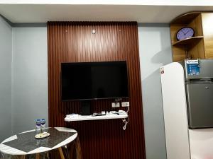 a living room with a television and a refrigerator at JAN Studio CDO Condo Stay in Lapasan +2 photos