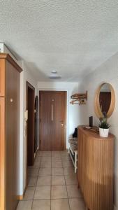 a room with a hallway with a desk and a mirror at Summit & Spring Studio - Leukerbad in Leukerbad