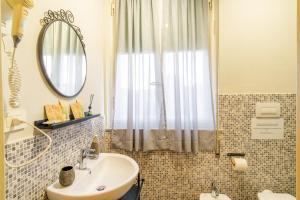 a bathroom with a sink and a mirror at Villa Catelli in Lucca +33 photos