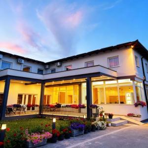 a large white building with flowers in pots at Hotel Residence Travnik in Travnik