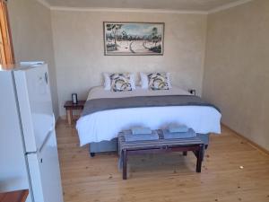 a bedroom with a bed with a table in it at Nardouw in Clanwilliam