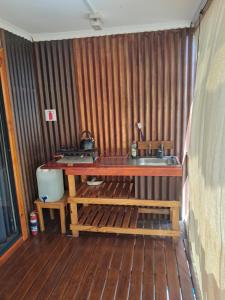 a kitchen with a sink and a wooden floor at Nardouw in Clanwilliam +20 photos