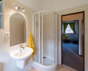a bathroom with a sink and a shower at Apartmány U Parku in Vrchlabí