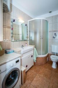 a bathroom with a washing machine and a sink at Apartment Damir in Tučepi +21 photos