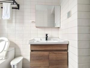 a white bathroom with a sink and a toilet at Chihiro Haven in Chongqing +44 photos