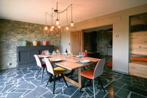 a dining room with a wooden table and chairs at Oklm6 in Mellet