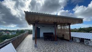 a patio with a table and chairs on a roof at Pradnya Homestay Ungasan - Room near Uluwatu in Uluwatu