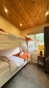 a bedroom with two bunk beds and a window at Cheerful 3 bedroom Lodge At White cross Bay Windermere in Windermere +63 photos