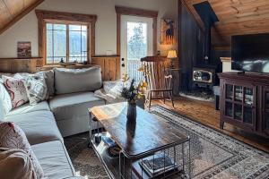 a living room with a couch and a table at Shadow Mountain Marina in Grand Lake