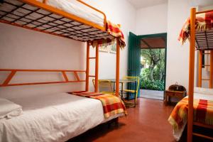 a bedroom with two bunk beds and a table at Hostel Layos, Toledo in Layos +55 photos