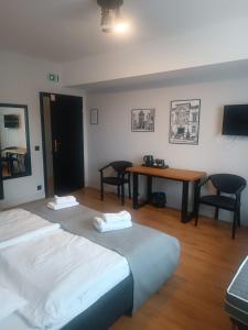 a room with two beds and a table with chairs at Polka in Chojnice