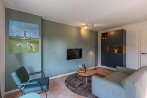 a living room with a couch and a table at Zeebries in De Koog