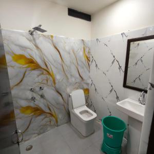 a bathroom with a toilet and a sink at Ruchi resort in Hisār