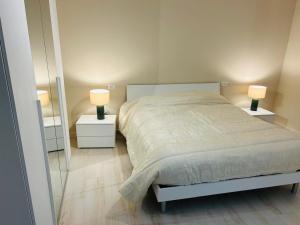 a bedroom with a bed and two lamps on night stands at Parrot House in Bertinoro