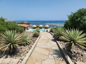 a walkway leading to a resort with the ocean at Kilulu Luxury Island, Watamu in Watamu