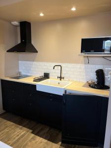 a kitchen with a sink and a counter top at Les Iris - Maison chaleureuse in Montigné-sur-Moine +22 photos