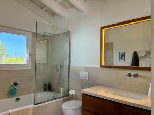 a bathroom with a toilet and a sink and a shower at Bella Mar in Son Carrio +10 photos