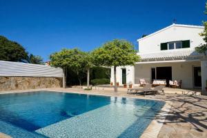 a swimming pool in front of a house at Bella Mar in Son Carrio