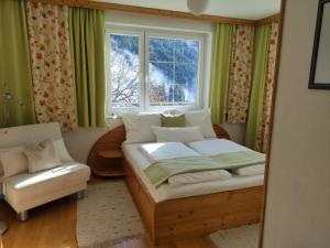 a small bedroom with a bed and a window at Ferienwohnung Kerschbaumer in Rangersdorf +51 photos