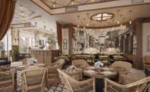 a restaurant with tables and chairs and a mural on the wall at Savoy 1918, a member of Small Luxury Hotels of The World in Oslo