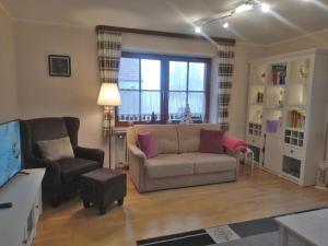 a living room with a couch and a chair at Im Haus am Ries in Ehingen am Ries