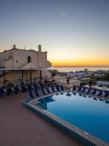 an aerial view of a resort with a pool and chairs at Hotel Tramonto d'oro Terme Casthotels in Forio d'Ischia