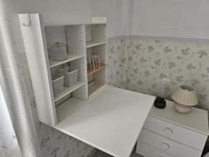 a small room with a white cabinet and a lamp at Solo or Couple , Solo o Pareja in Seville