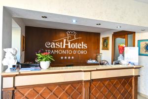 a restaurant counter with a sign on the wall at Hotel Tramonto d'oro Terme Casthotels in Forio d'Ischia