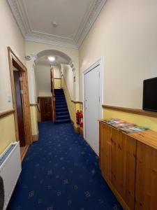 a hallway with stairs and a television in a room at ABC House in Dublin
