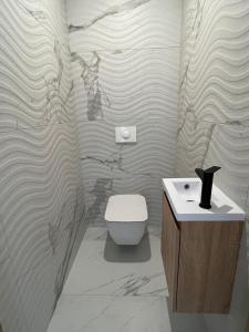 a bathroom with a toilet and a sink at Rare T2 New, Waterfront in Porticcio