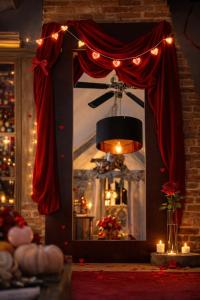a mirror with a red curtain and lights and candles at Au2 Maison d'Hôtes - Guest House Au2 in Muidorge +65 photos