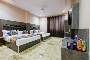a hotel room with two beds and a television at Hotel Square Plaza At Airport in New Delhi