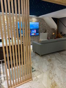 a living room with a couch and a tv at Maison in Maisdon-sur-Sèvre +6 photos