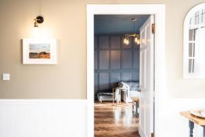 a hallway with a door leading into a living room at Northern Hideaways, Sunnyside, Otterburn in Otterburn