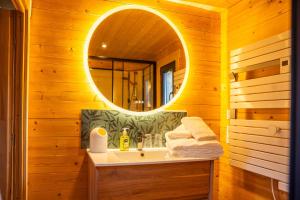a bathroom with a sink and a mirror at Gîte de charme Ò Chalet in Camors +15 photos