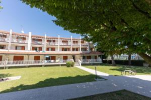 a large building with a park in front of it at Residence Selenis Apartments in Caorle