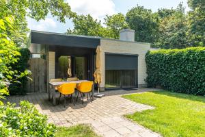 a patio with a table and chairs in a yard at Zilte Bries in De Koog +5 photos