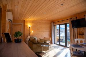 a living room with a couch and a table at Gîte de charme Ò Chalet in Camors