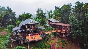 an aerial view of a house in the forest at มาดูดอย - Madoodoi in Ban Mae Na +12 photos