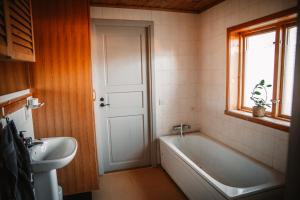 a bathroom with a tub and a toilet and a sink at Gårdshuset på Wrågården in Falköping +15 photos