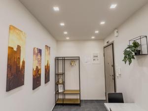 a room with white walls and paintings on the wall at Athenian Hideaway - Spa Tub and Walk to Metro in Athens