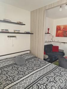a bedroom with a bed and a couch at Apartmán Mery in Podhájska