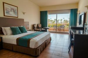a hotel room with a bed and a balcony at Hurghada Long Beach Resort in Hurghada