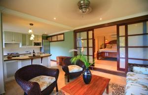 a kitchen and living room with a table and chairs at Villa C'est La Vie in Rodney Bay Village