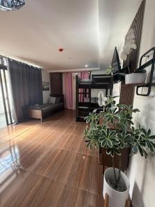 a living room with a couch and a potted plant at EA Staycation in Baguio
