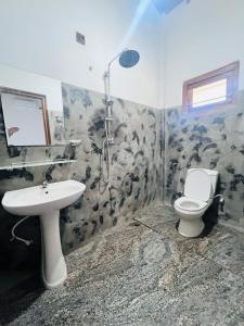 a bathroom with a toilet and a sink at Sunil VIlla in Talpe