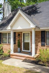 a brick house with a front door with a potted plant at King 3bedroom, centrally located in Augusta