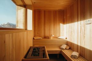 a sauna with a window and a bench in it at Lodji Hotel & spa in Saint-Martin-de-Belleville